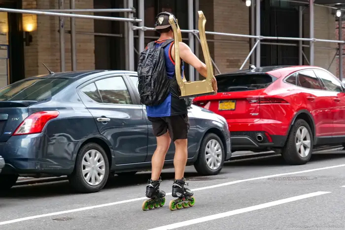 A man on Rollerblades holding a small table